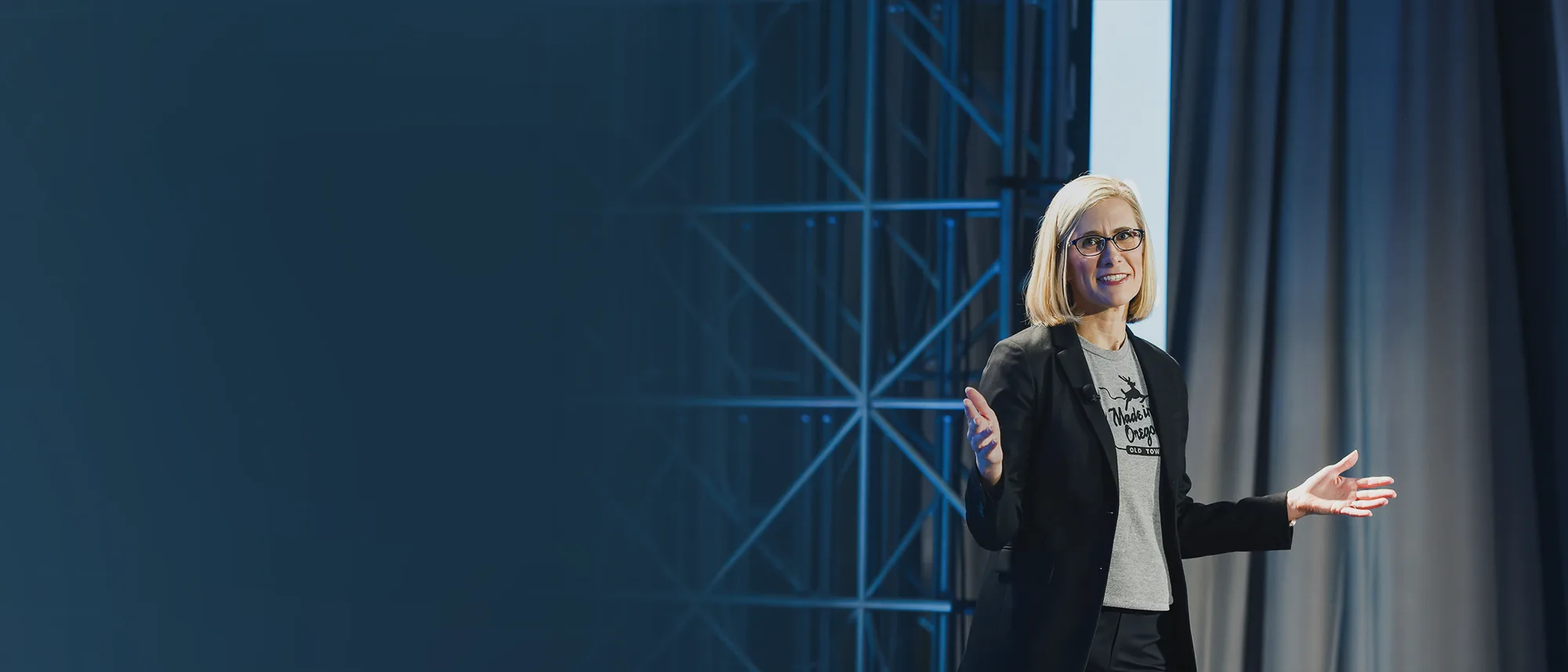 Amber Simonsen speaking on stage with a microphone